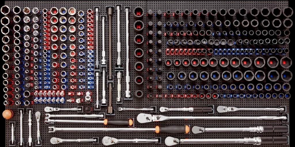 ToolGrid modular tool organization system, boards with a grid of holes and specialized holders keeping tools secure and visible
